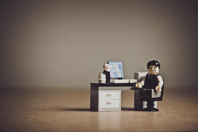 man figure at office desk